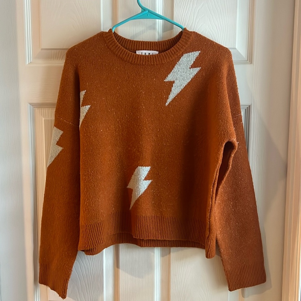Orange sweater with white lightning bolts. Size small. Like New. THML brand
